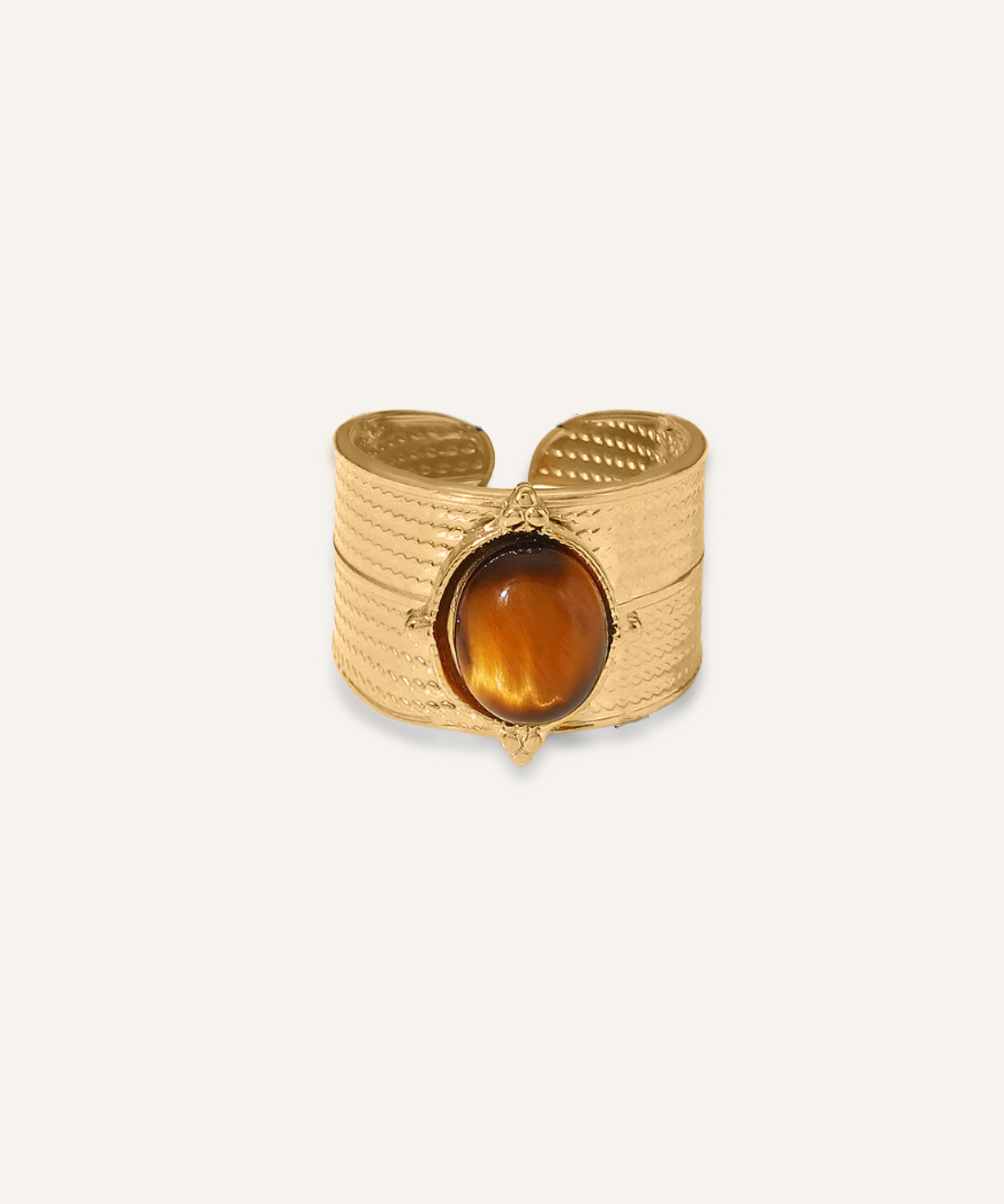 Sola Ring featuring a tiger eye stone set on a bold gold wave band.