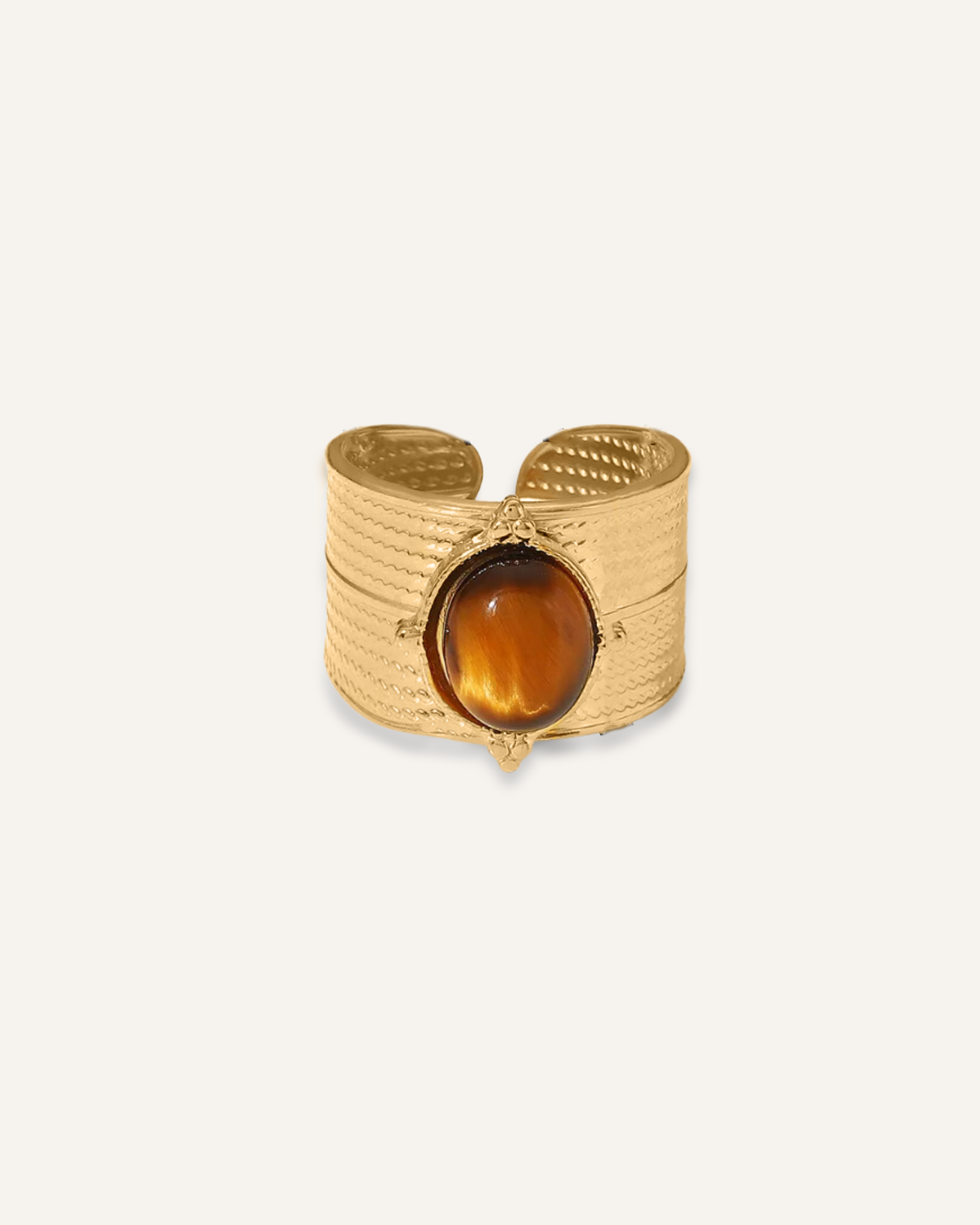 Sola Ring featuring a tiger eye stone set on a bold gold wave band.