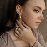 Second side view of Tyla Earrings worn with a minimal outfit.
