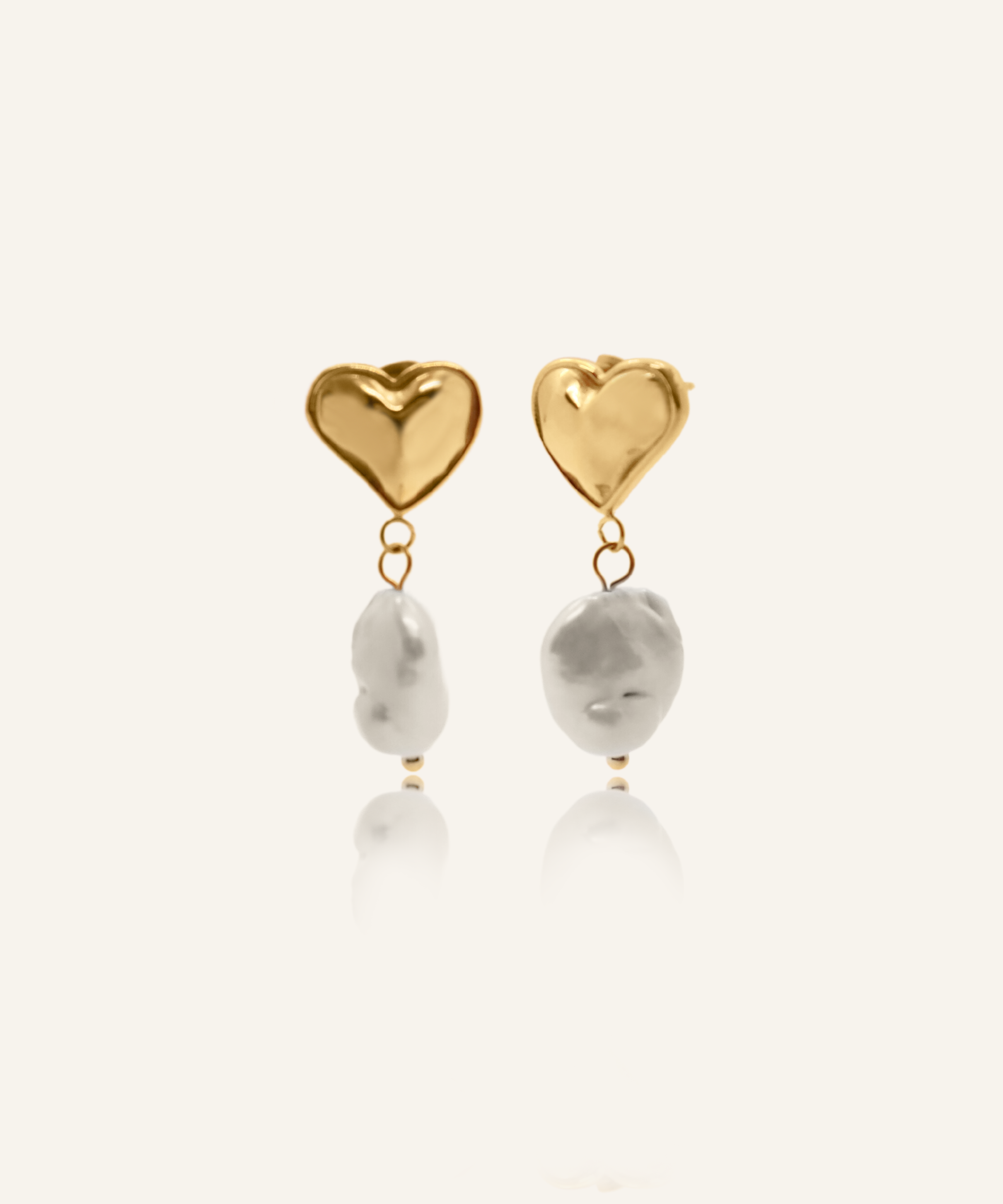 Valentina heart-shaped gold earrings with flat baroque pearls.