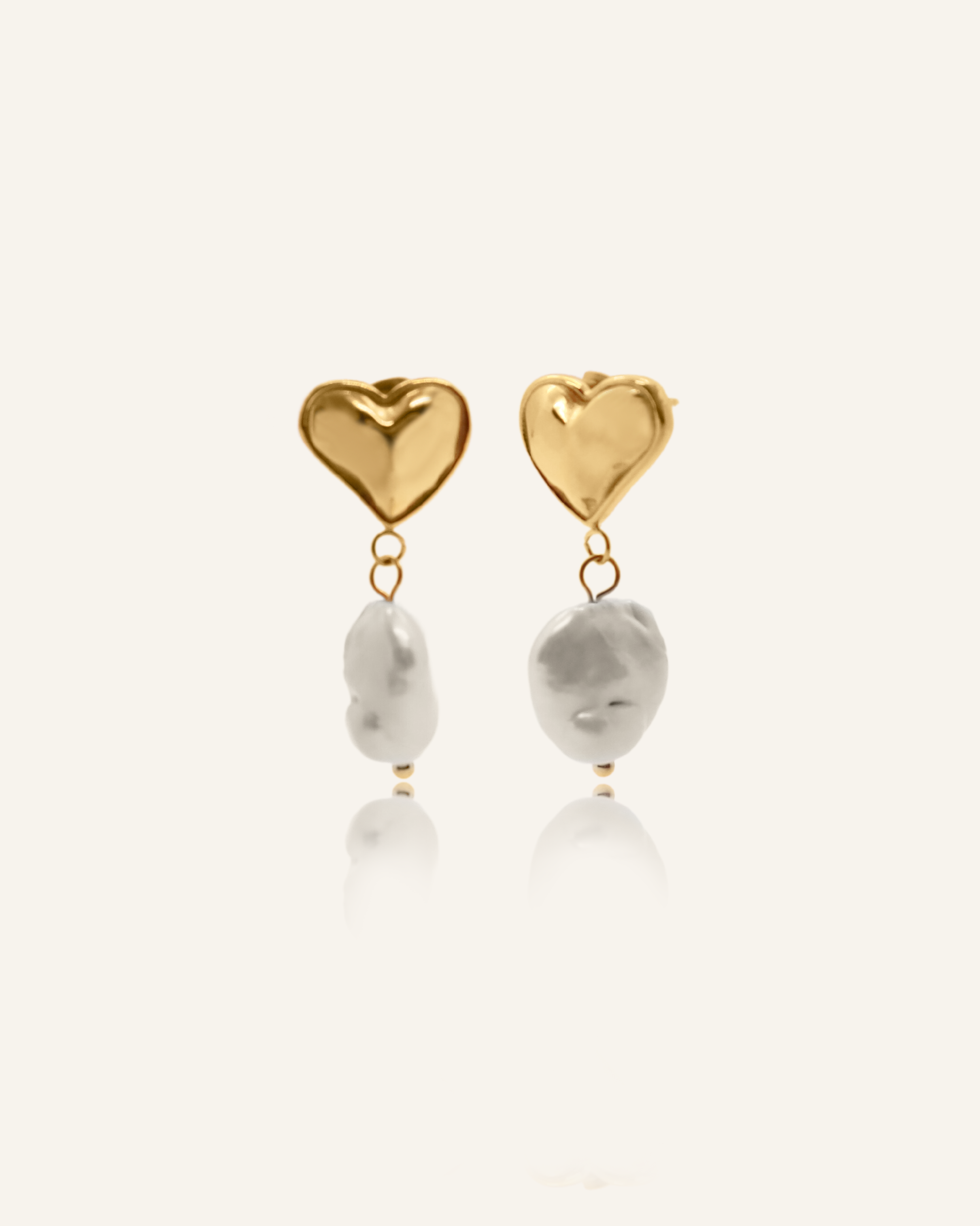 Valentina heart-shaped gold earrings with flat baroque pearls.