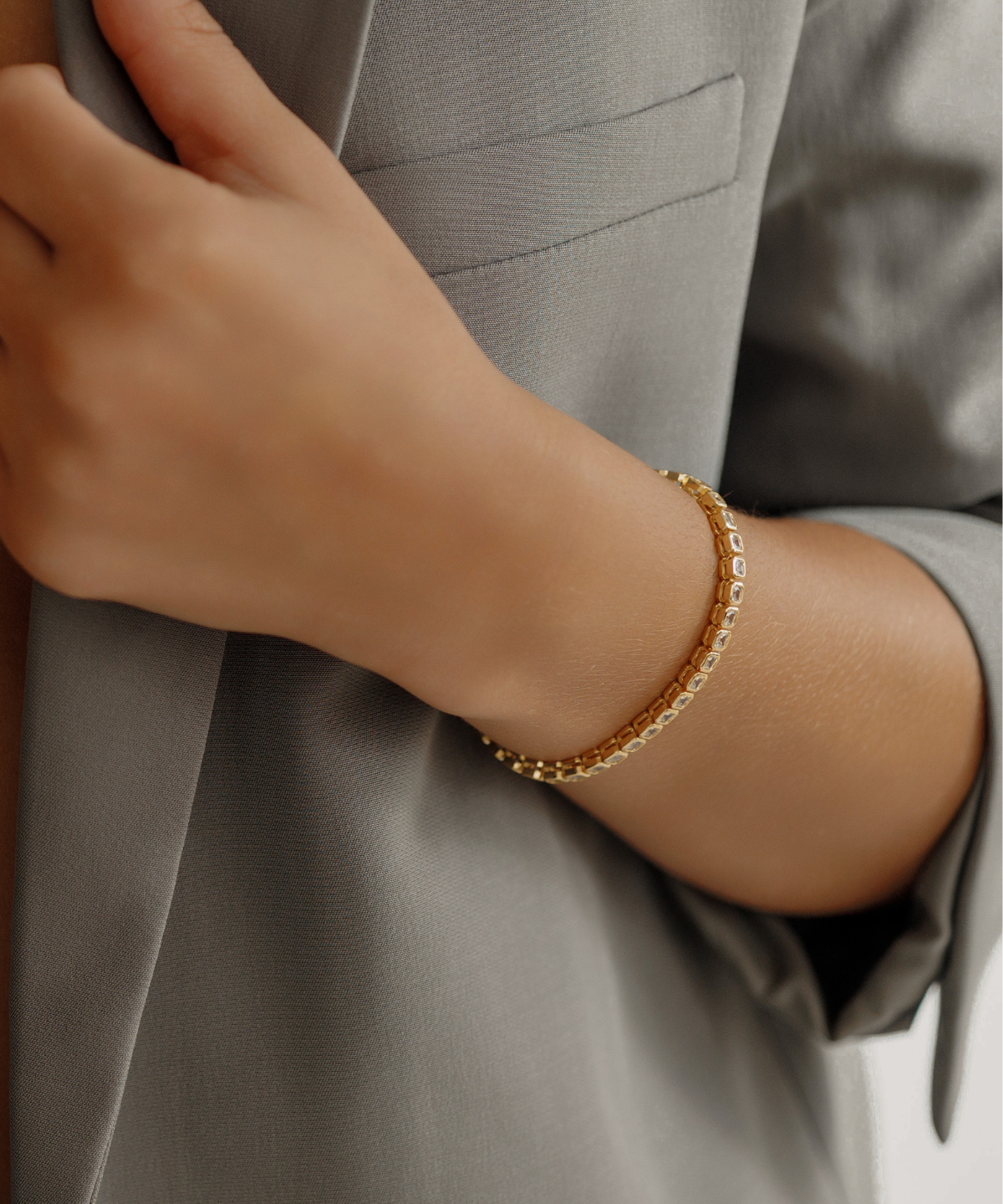 18K gold Zara Bracelet worn as a daily piece featuring square-cut zirconia stones.