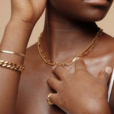 Closeup view of the Amelia Necklace worn, showcasing its delicate gold ball texture.
