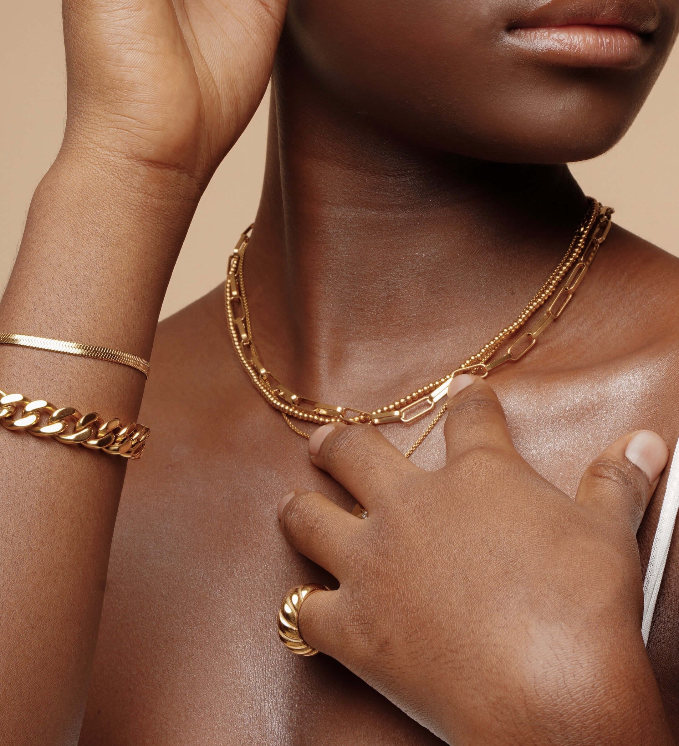 Closeup view of the Amelia Necklace worn, showcasing its delicate gold ball texture.