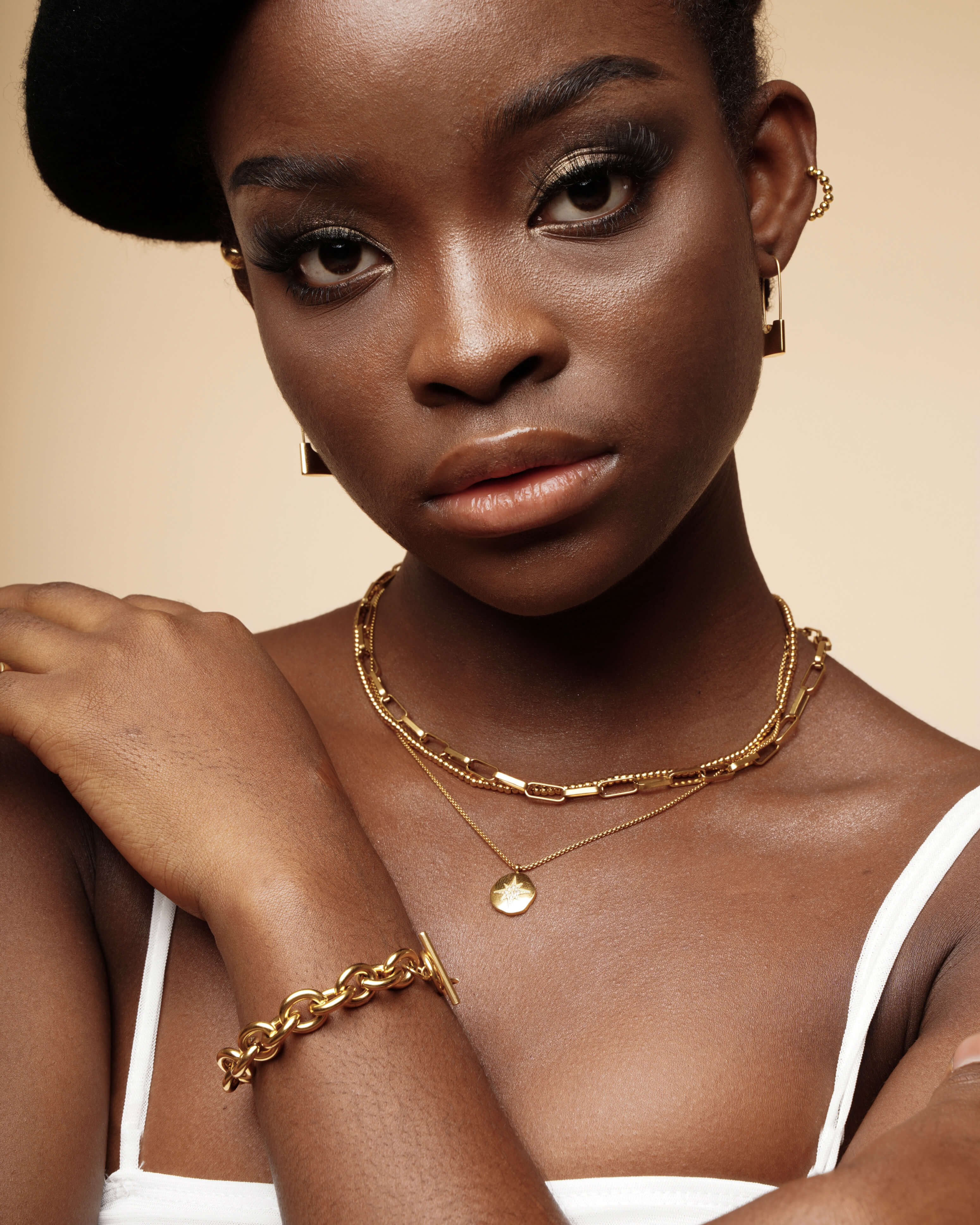 Detailed closeup of the Amelia Necklace layered on skin, highlighting its fine craftsmanship.
