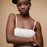 Portrait shot of Amelia Necklace worn with a minimal outfit, showing elegant gold tone.