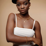 Portrait shot of Amelia Necklace worn with a minimal outfit, showing elegant gold tone.