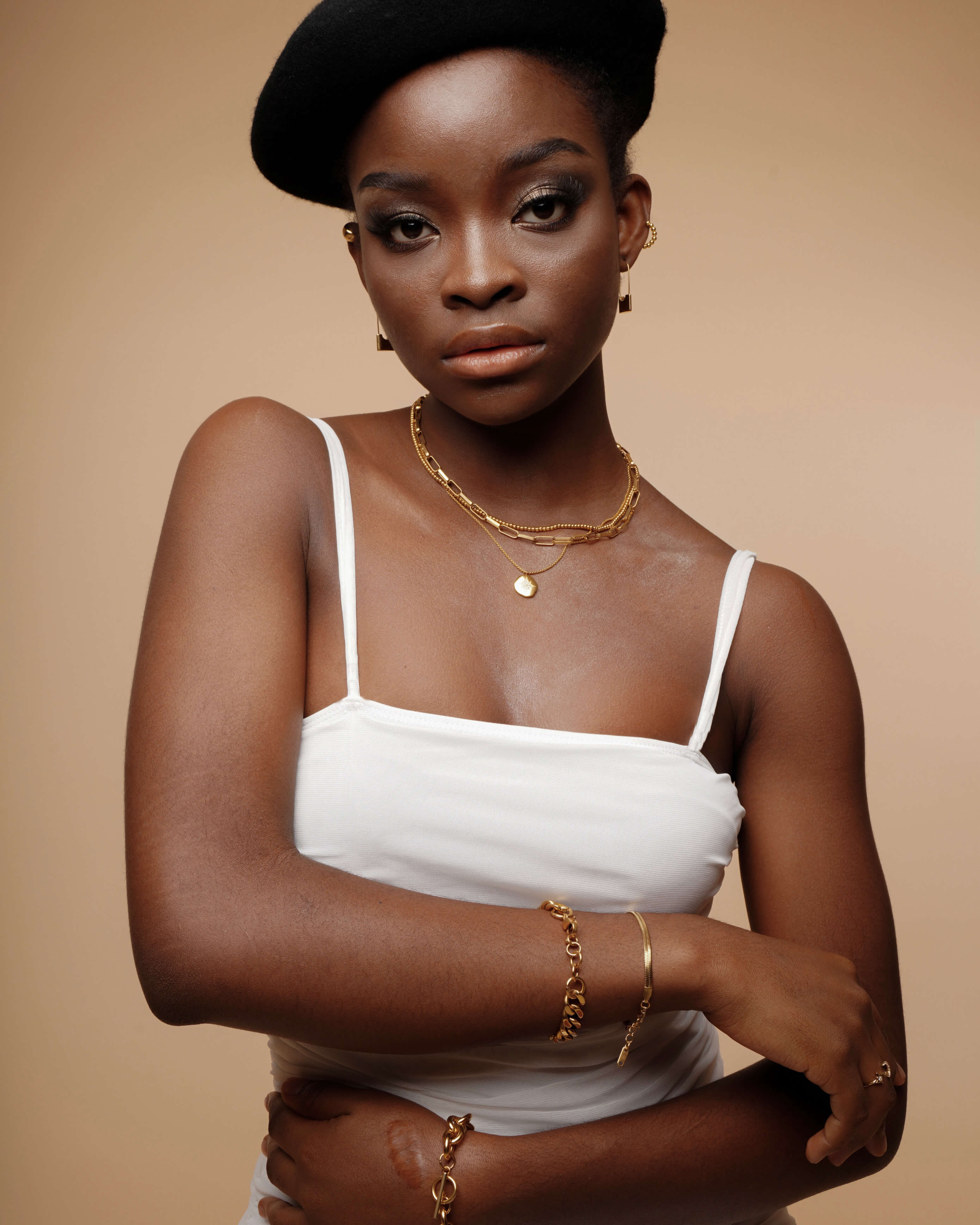 Portrait shot of Amelia Necklace worn with a minimal outfit, showing elegant gold tone.