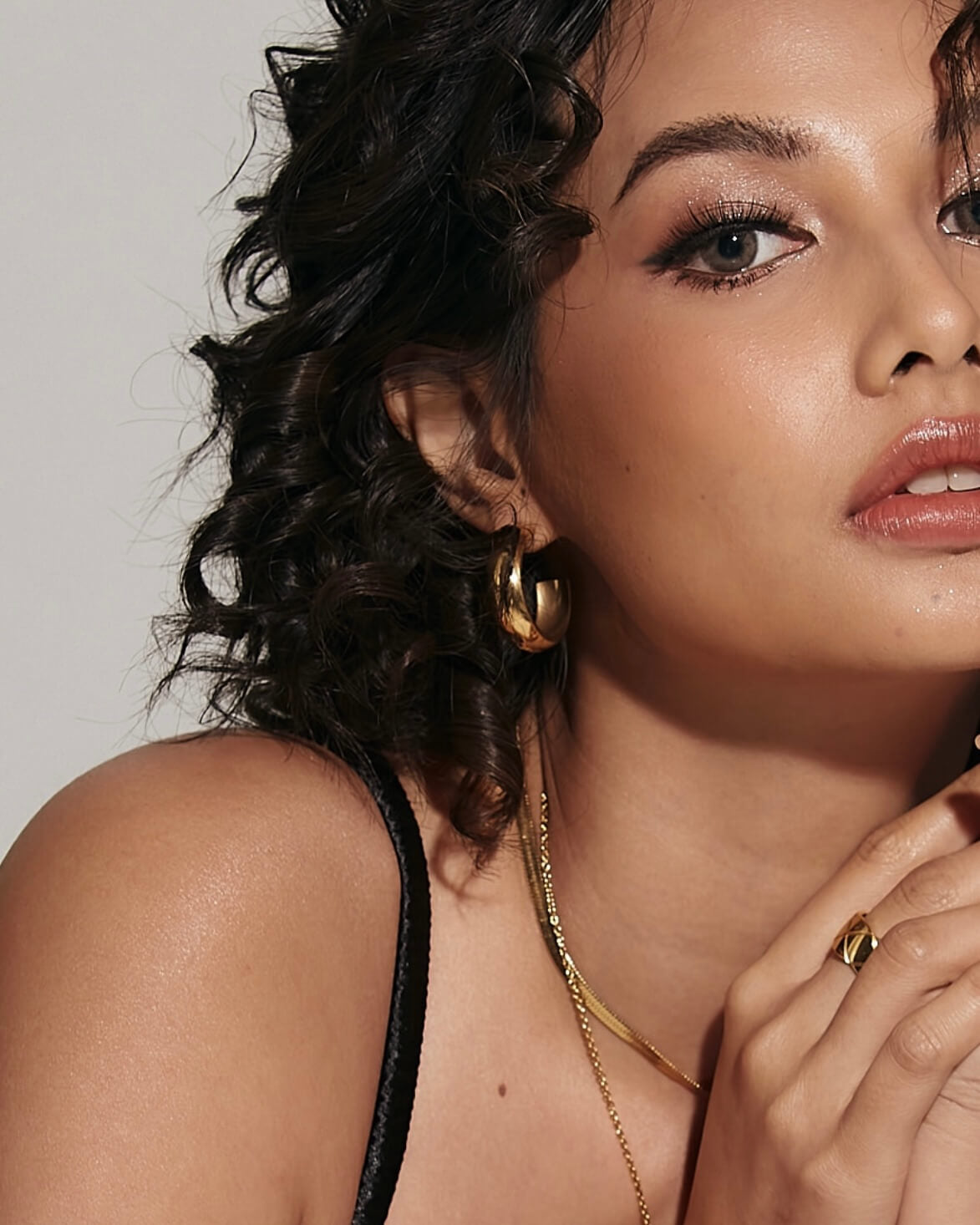 Closeup of Armani Earrings worn, highlighting clean, concave drop.