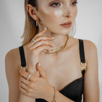 Front view of model wearing Ayla Earrings with gold and zirconia details.