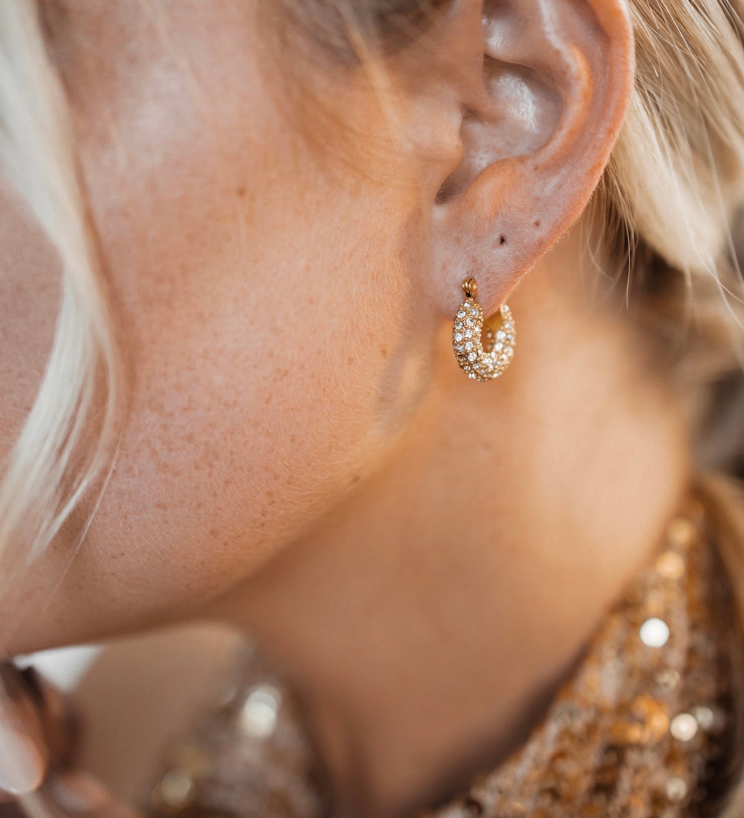 Closeup view of Belle Earrings worn, showing 360° zirconia sparkle.