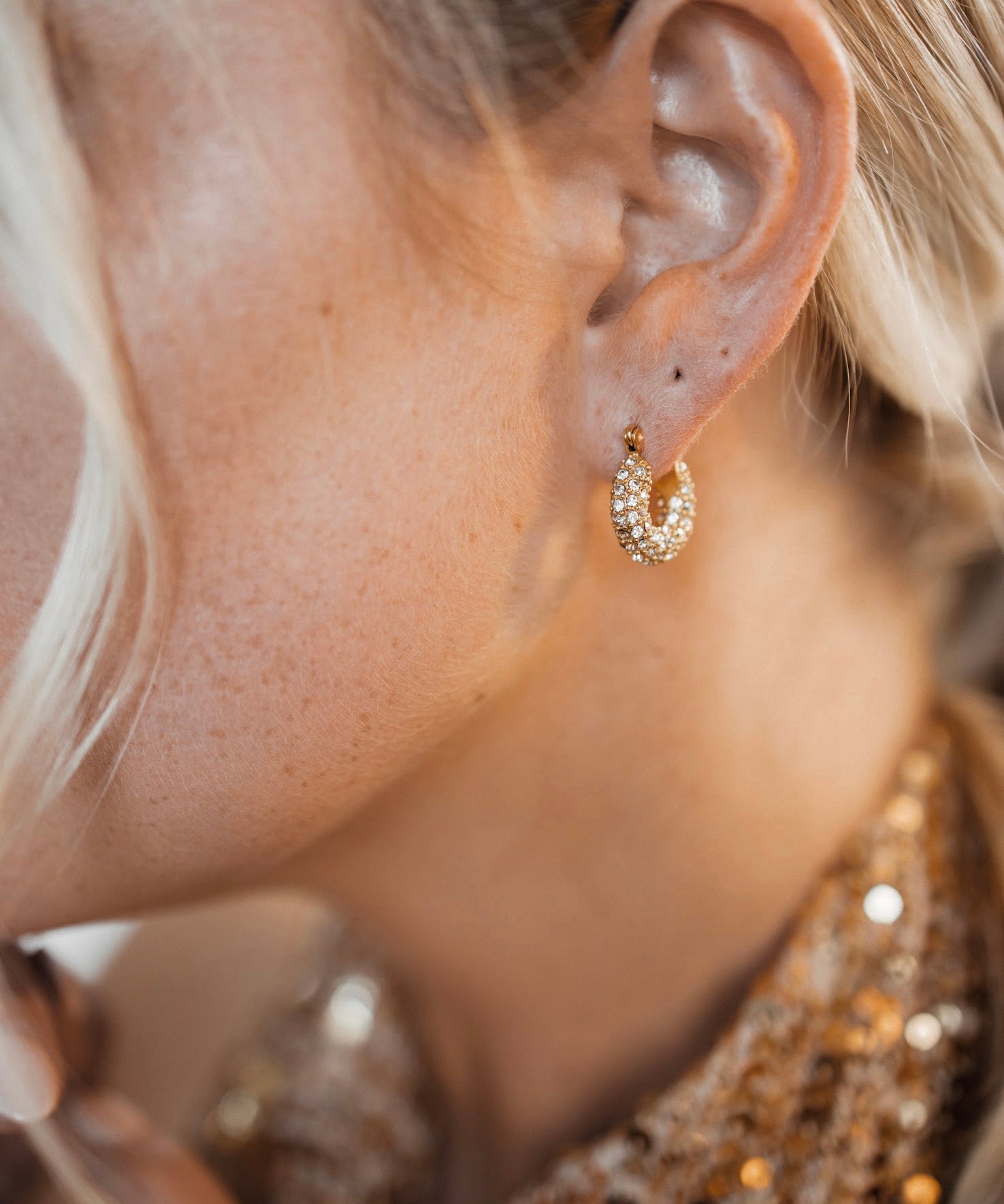 Closeup view of Belle Earrings worn, showing 360° zirconia sparkle.