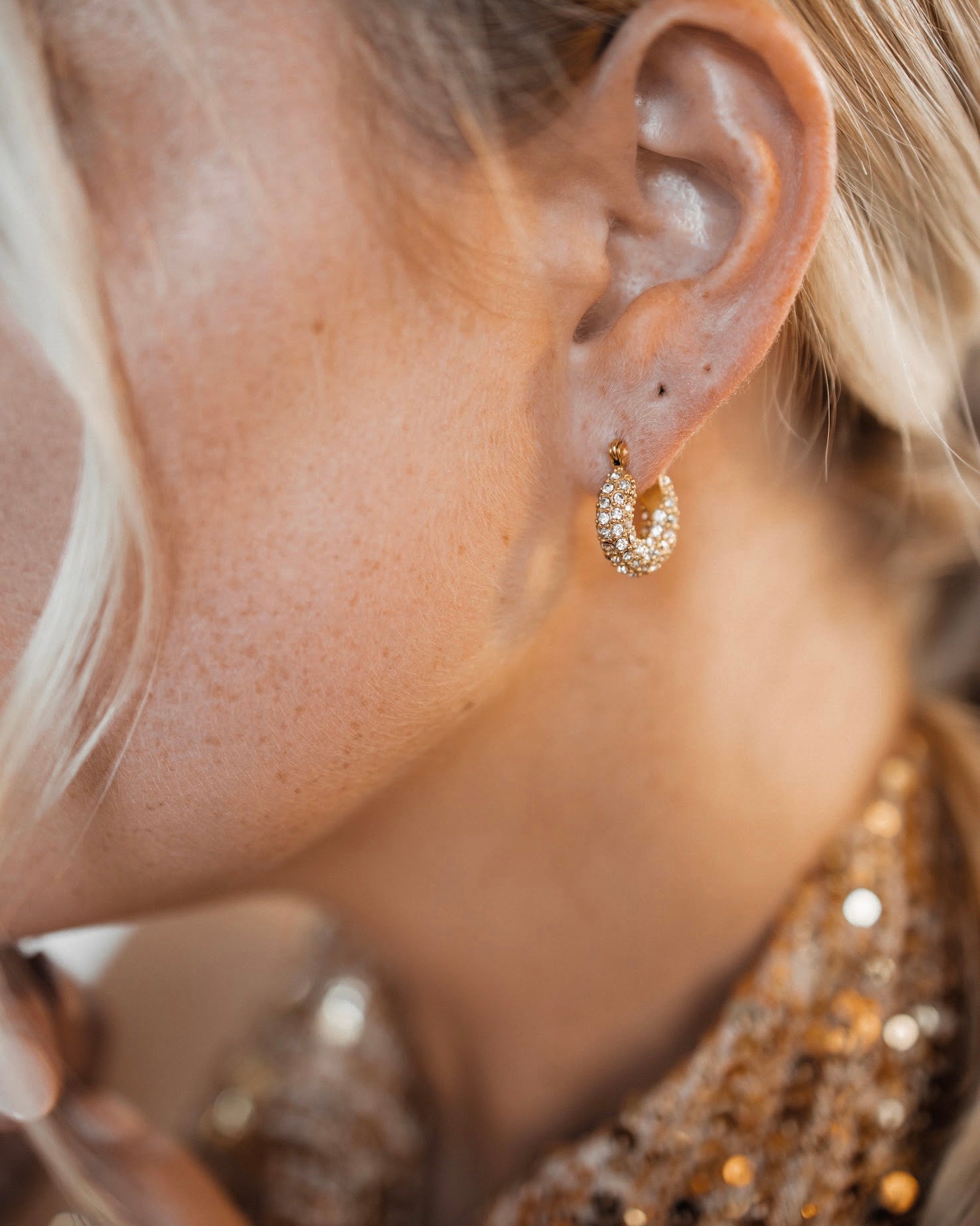 Closeup view of Belle Earrings worn, showing 360° zirconia sparkle.