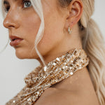 Belle Earrings worn with side view highlighting gold and zirconia.