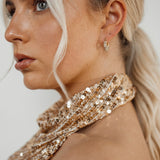 Belle Earrings worn with side view highlighting gold and zirconia.