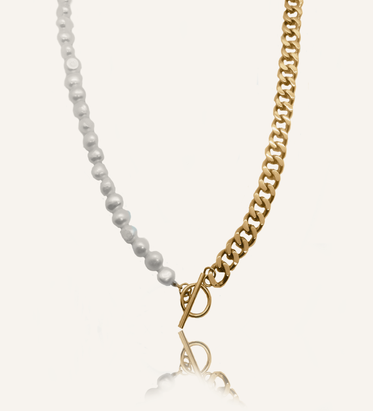 Flatlay image of Blanche Necklace with half gold curb chain and half freshwater pearls.