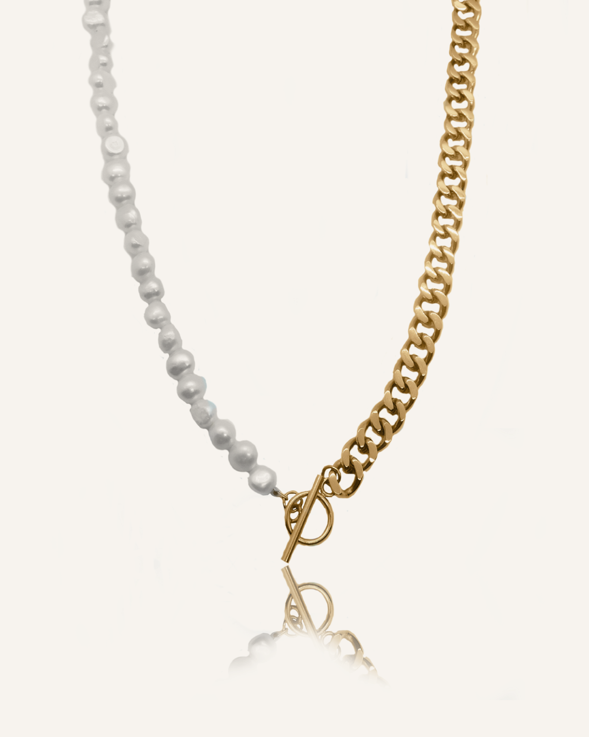 Flatlay image of Blanche Necklace with half gold curb chain and half freshwater pearls.