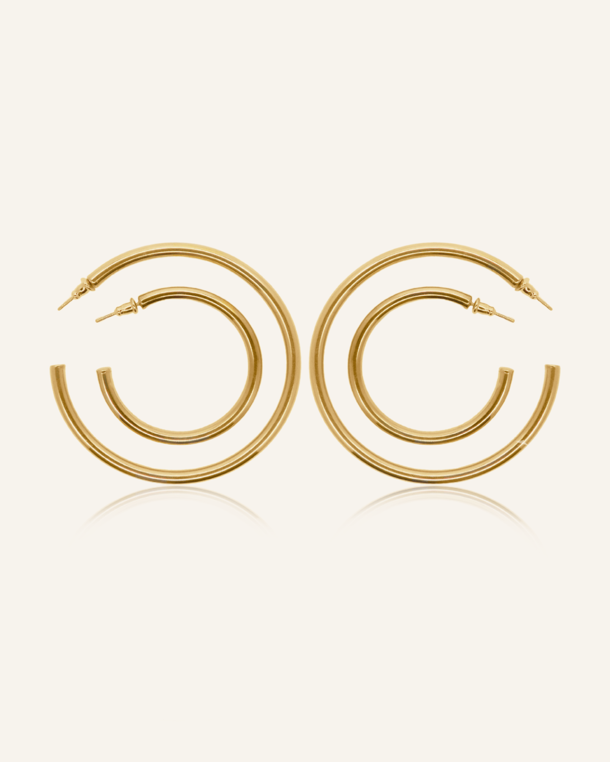 Callista gold hoop earrings in 18k coating, available in three sizes with a classic silhouette.