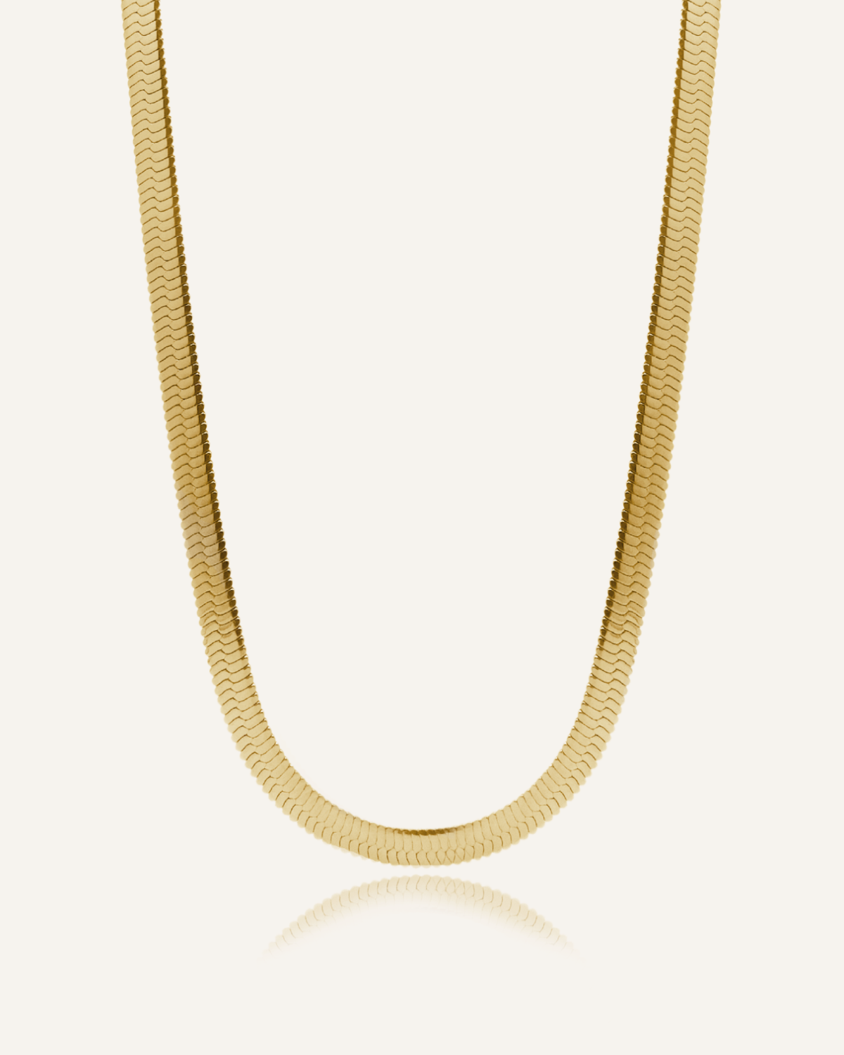 Flatlay of Capri Necklace showing its bold gold herringbone chain design.