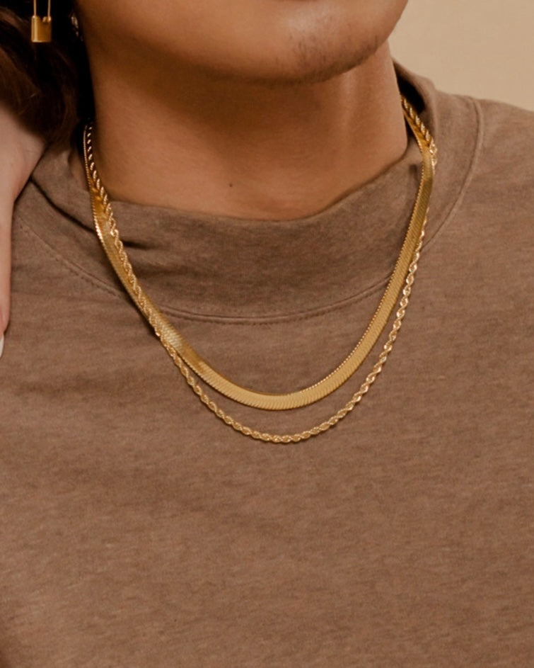 Closeup of Capri Necklace worn to highlight its thick and sleek gold chain texture.
