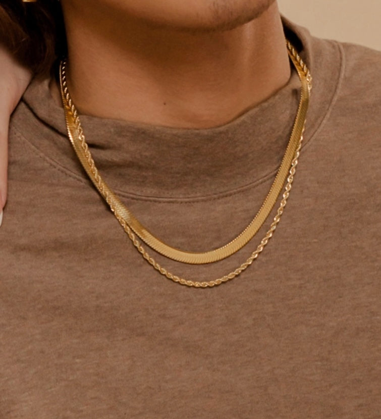 Closeup of Capri Necklace worn to highlight its thick and sleek gold chain texture.