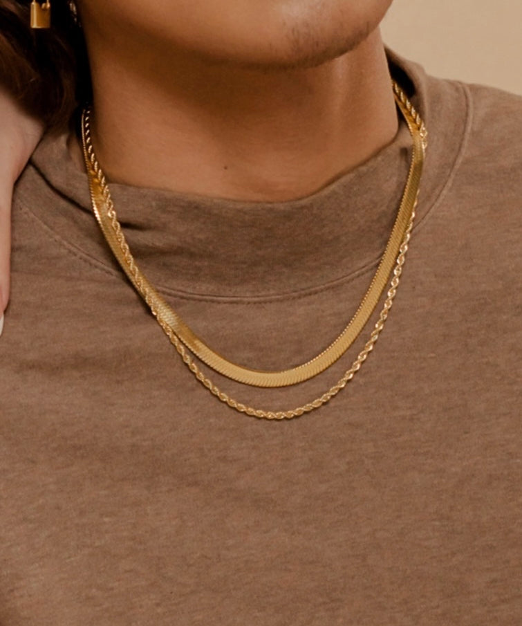 Closeup of Capri Necklace worn to highlight its thick and sleek gold chain texture.