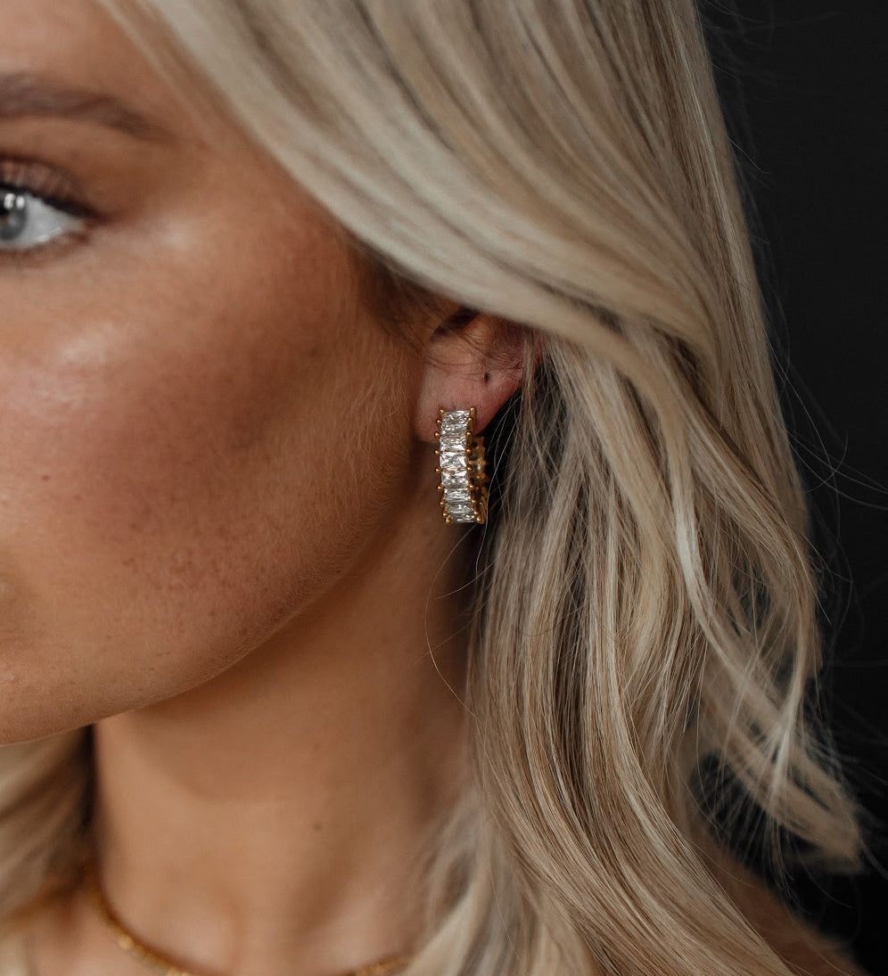 Closeup of Ciana Earrings worn, showing semi hoop zirconia sparkle.