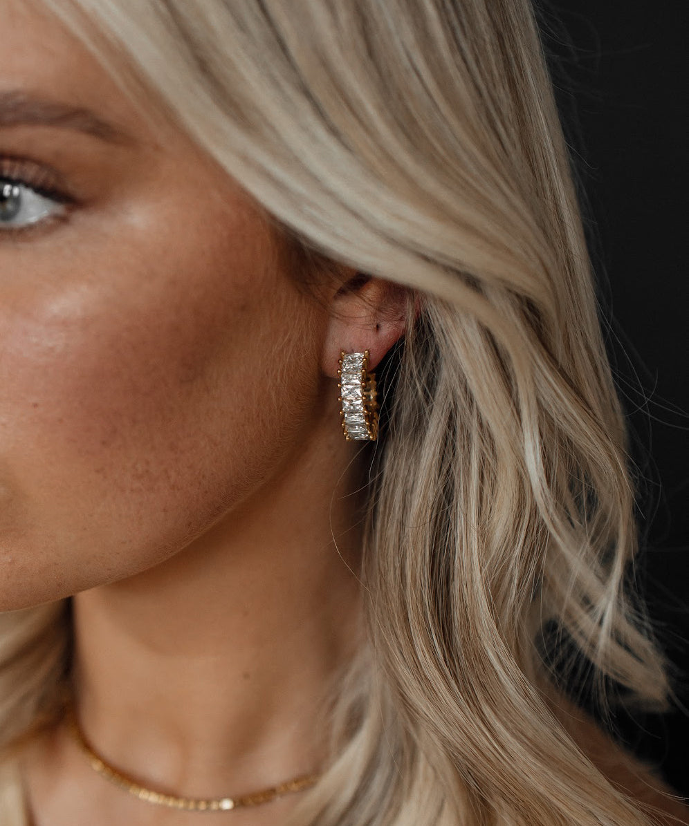 Closeup of Ciana Earrings worn, showing semi hoop zirconia sparkle.