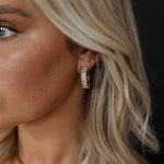 Closeup of Ciana Earrings worn, showing semi hoop zirconia sparkle.