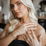 Front half-body view showing Ciana Earrings' elegant shine.