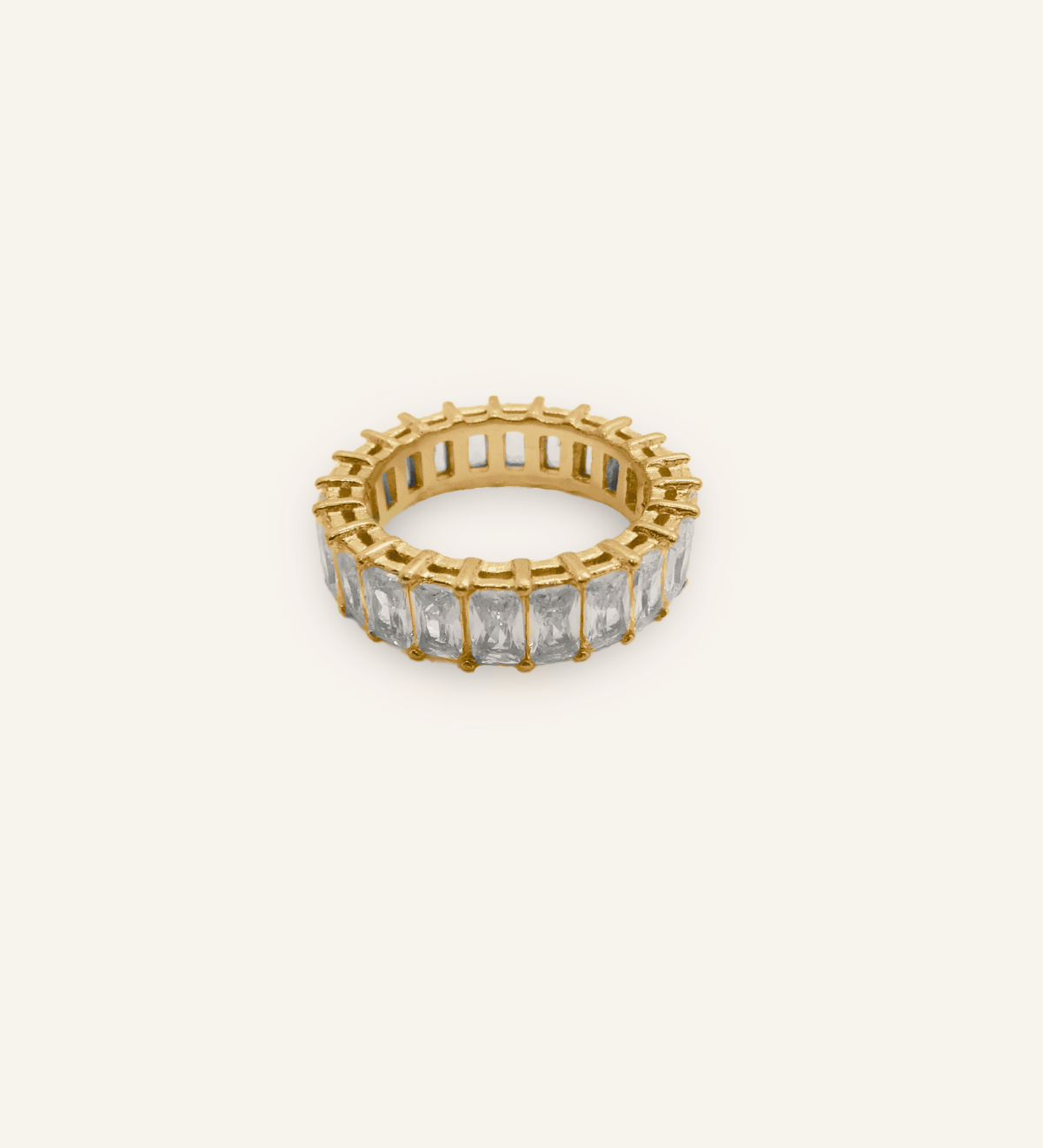Flatlay of Ciana Ring featuring rectangular zirconia stones set in 18K gold-coated band.