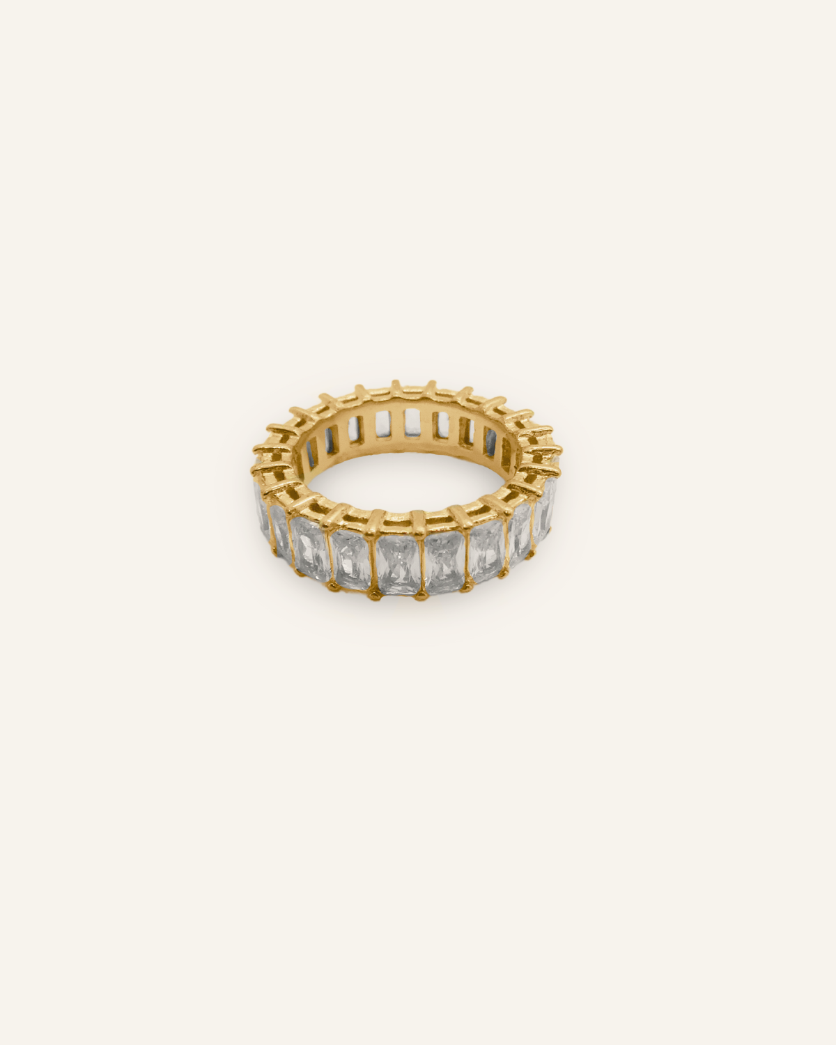 Flatlay of Ciana Ring featuring rectangular zirconia stones set in 18K gold-coated band.