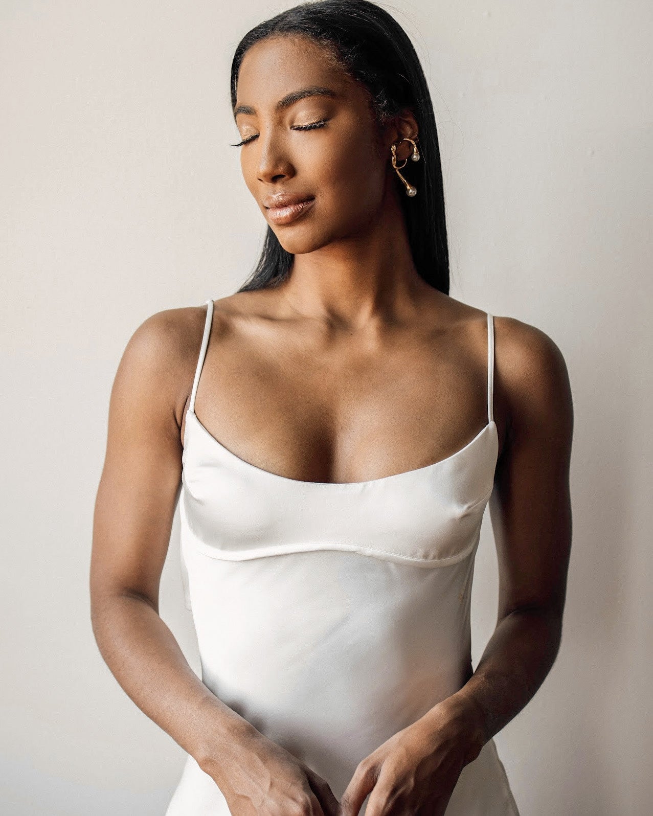 Half-body view of model wearing Dahlia Ear Cuff styled with a minimal outfit.