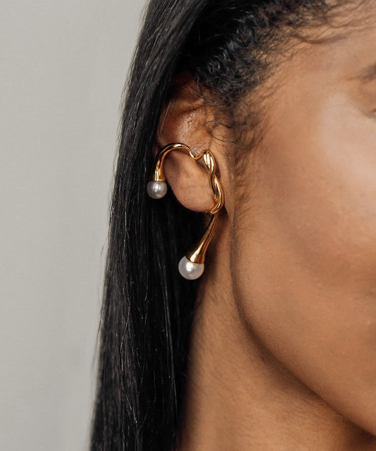 Closeup view of Dahlia Ear Cuff worn on ear showing pearl accents and branch design.