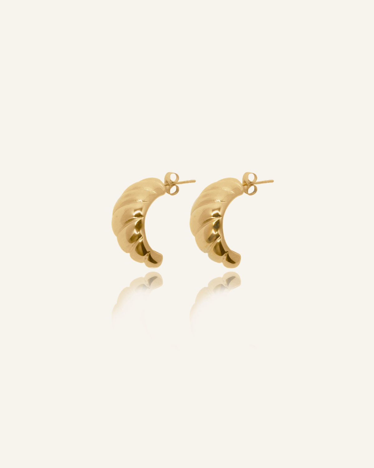 Demi Earrings product image showcasing twisted gold hoop design.