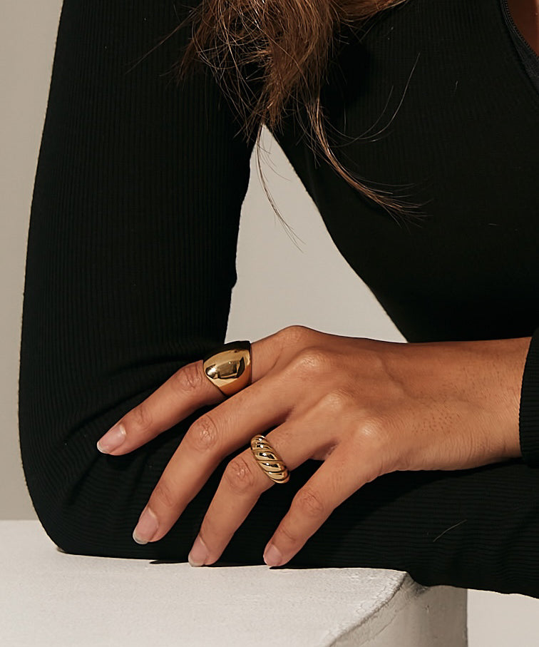Closeup of the Diana Ring worn, showcasing thick gold statement style.