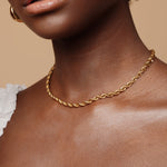 Closeup of Fiona Necklace worn, highlighting the thick rope design and gold finish.