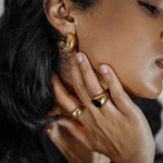 Side angle closeup of Gaia Earrings worn to display the curved semi-hoop profile.