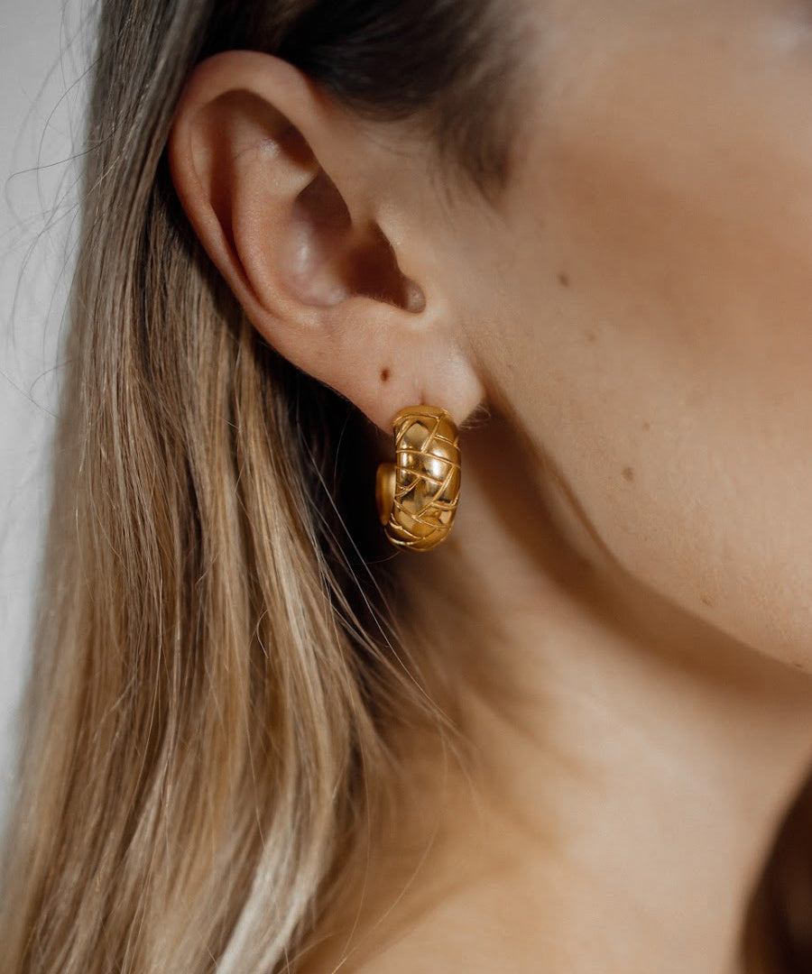 Closeup of Gaia Earrings worn, highlighting dome shape and intricate details.