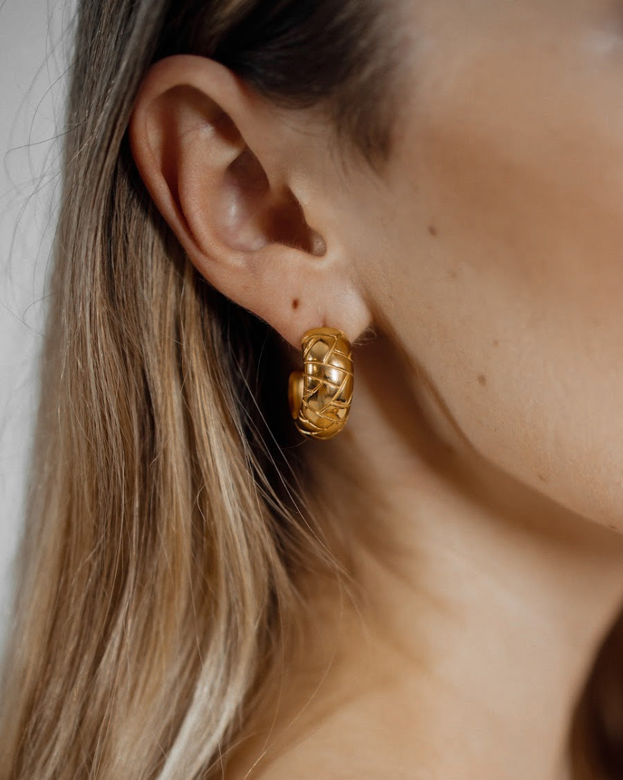 Closeup of Gaia Earrings worn, highlighting dome shape and intricate details.