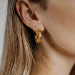 Closeup of Gaia Earrings worn, highlighting dome shape and intricate details.