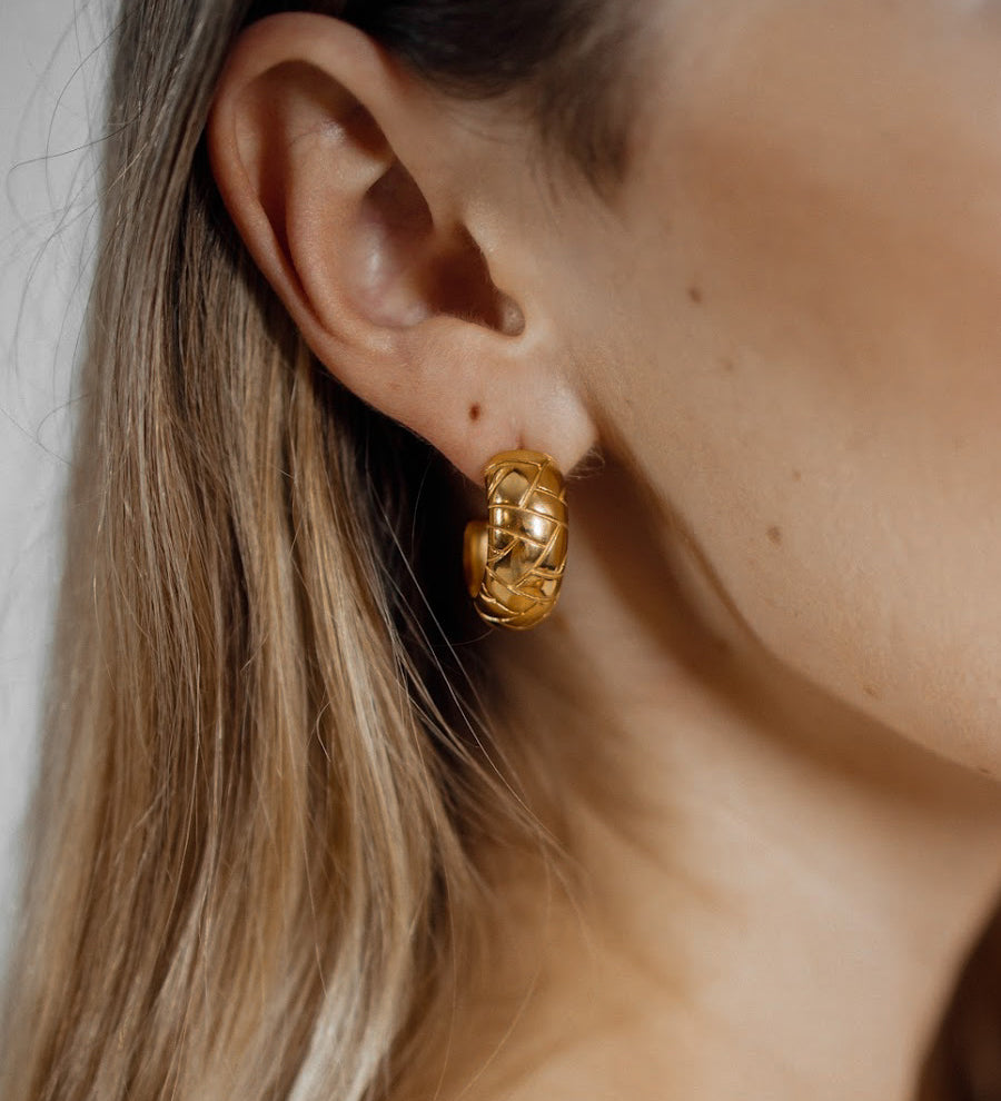 Closeup of Gaia Earrings worn, highlighting dome shape and intricate details.