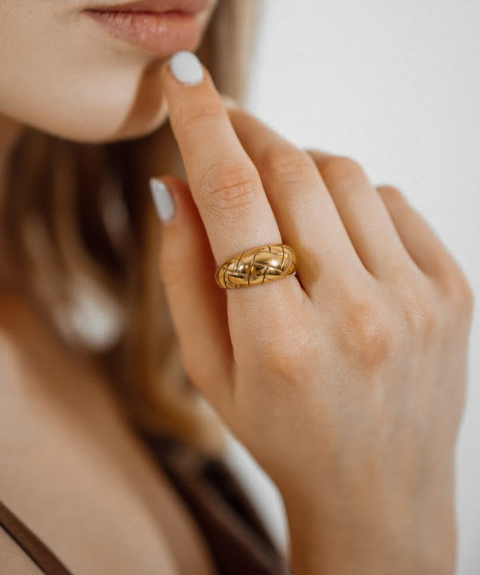 Closeup of Gaia Ring worn on hand, highlighting its bold and textured dome shape.