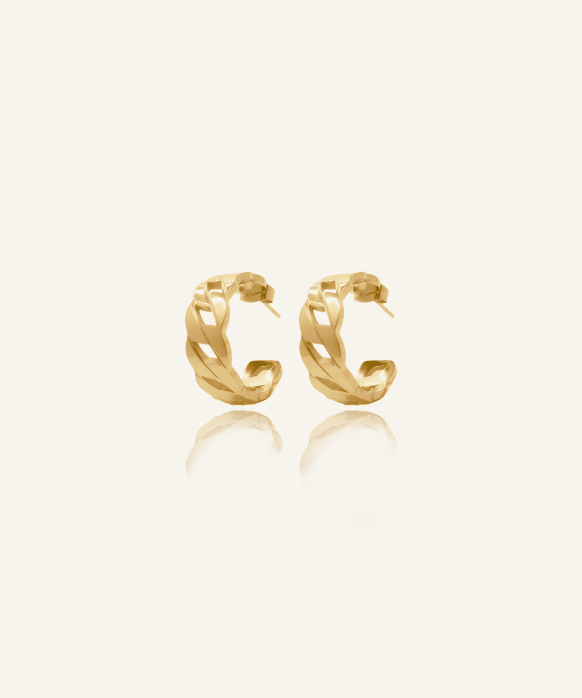 Product flatlay of Kalani Earrings showing gold Cuban link huggie design.