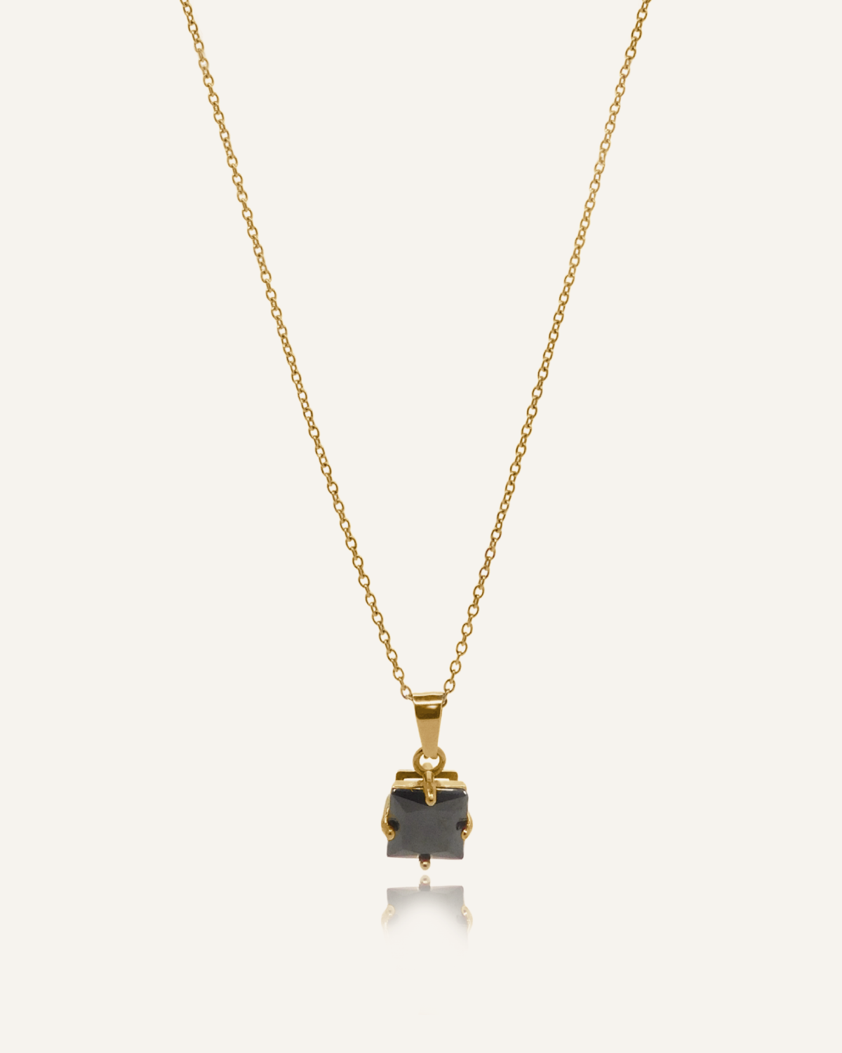 Kamaria Necklace with a bold black onyx pendant on an 18k gold-coated cable chain.