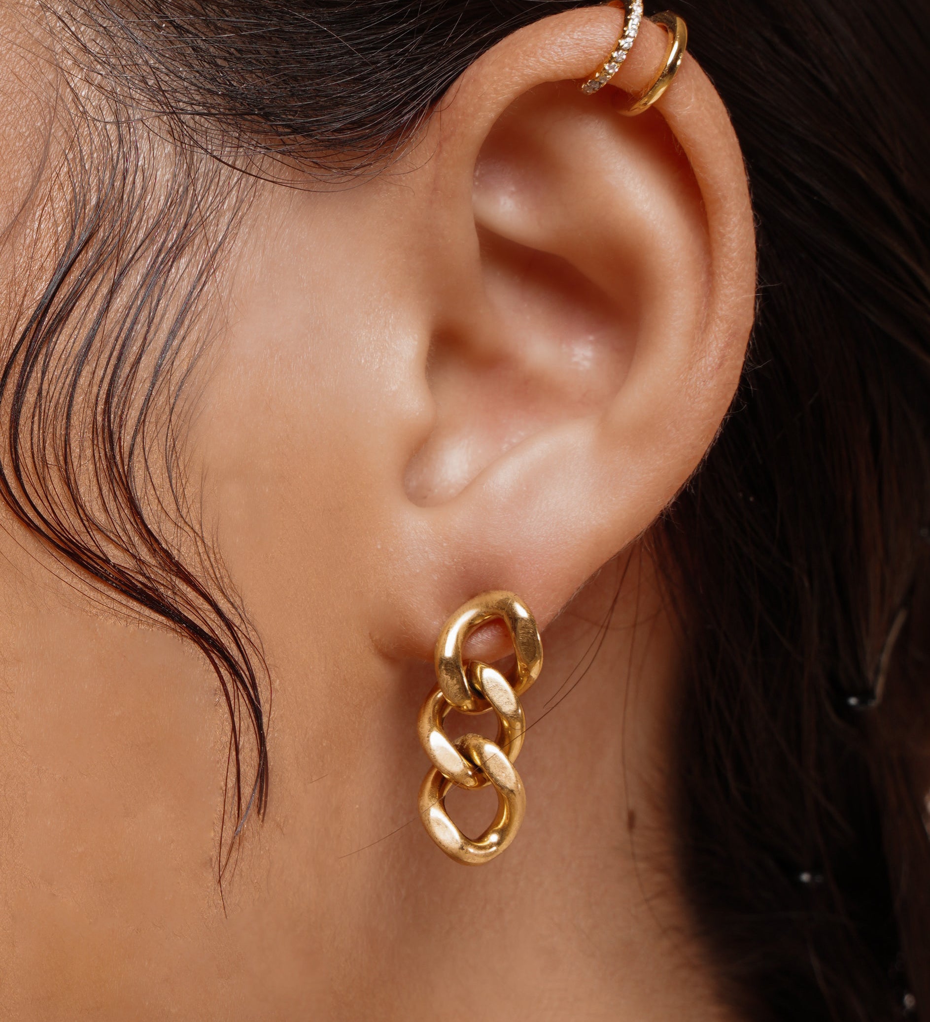 Closeup of Kyra Earrings worn on ear, showing off the bold chain link design.