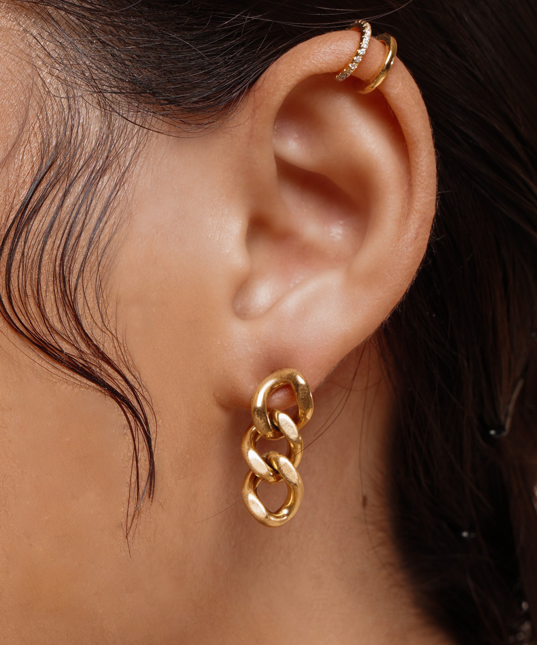 Closeup of Kyra Earrings worn on ear, showing off the bold chain link design.