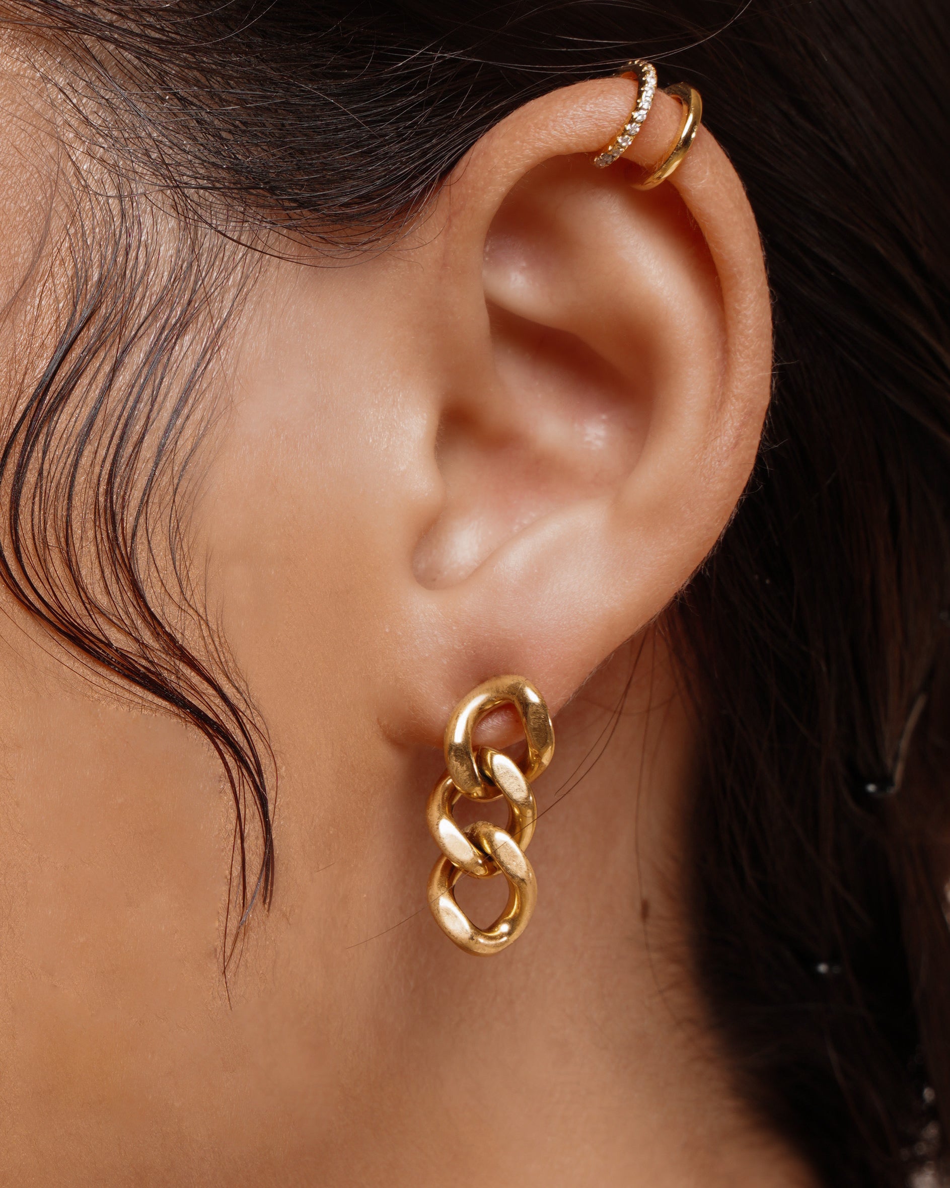Closeup of Kyra Earrings worn on ear, showing off the bold chain link design.