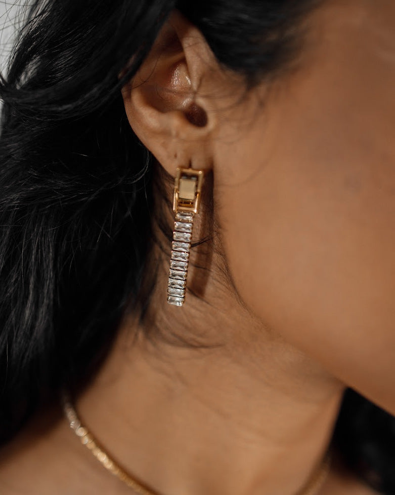 Closeup of Laena Earrings worn, showcasing dazzling zircon dangle.