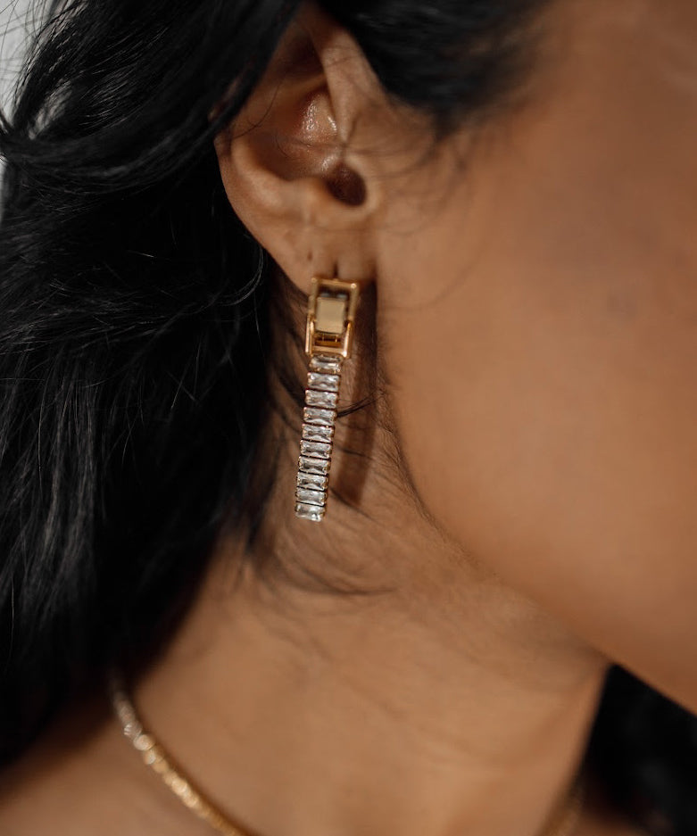 Closeup of Laena Earrings worn, showcasing dazzling zircon dangle.